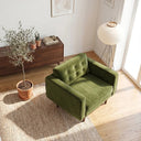 Casey olive green velvet armchair with a button-tufted back cushion and tapered wood legs, placed on a woven rug in a bright modern living room.