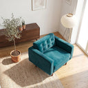 Casey teal velvet armchair with a button-tufted back and tapered wooden legs on a woven rug in a sunlit modern living room.