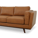 Close-up of the Chase 90 mid-century modern tan genuine top-grain leather sofa with tapered wooden legs, isolated on a white background.