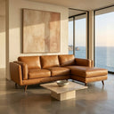Chase 91-inch tan genuine leather right-facing sectional sofa with chaise lounge set in a modern sunlit living room with ocean views.