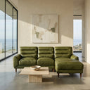 Chiara 97-inch green genuine leather sectional sofa with right chaise lounge and tapered wood legs in a modern minimalist living room with ocean view.