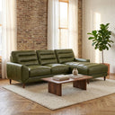 Chiara 97-inch olive green genuine leather sectional sofa with right-facing chaise styled in a modern living room with exposed brick walls, a wooden coffee table, and a cream area rug.