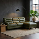 Chiara 97-inch green genuine leather sectional sofa with right-facing chaise and channeled backrest cushions, styled in a modern dark living room with an arched floor lamp.