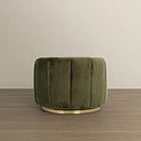 Back view of a modern round barrel swivel armchair upholstered in plush olive green velvet with vertical channel tufting along the curved exterior, supported by a circular brushed brass swivel base resting on light wood flooring against a neutral background.