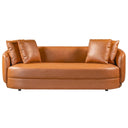 Dina 85 modern cognac leather sofa with matching leather throw pillows against a solid white background, featuring a curved silhouette, low back, and rounded arms.