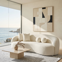Modern living room with a white sofa, abstract painting, and ocean view.