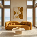 Elissa 93-inch Japandi mustard yellow boucle sofa with round and bolster pillows in a modern coastal living room featuring a travertine coffee table, abstract wall art, and scenic ocean views.