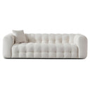Elizia 86-inch modern Chesterfield cream boucle sofa featuring a low-profile tufted design and matching accent pillow against a solid white background.