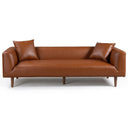 Erling 86-inch cognac brown vegan eco-leather sofa with two matching throw pillows and tapered wooden legs, isolated on a white background.