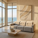Franca 107-inch light grey velvet power slider sofa in a modern sunlit living room with ocean views and a travertine coffee table.