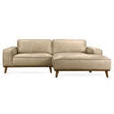 Katia 98-inch beige leather right-facing sectional sofa with chaise lounge and tapered wood legs, front view against a white background