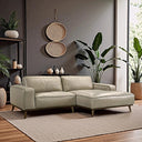 Katia 98-inch beige leather right-facing sectional sofa with wide track arms and tapered wooden legs, set on a neutral woven rug in a modern living room with a dark gray wall, hanging woven baskets, and lush indoor plants.
