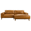 Katia 98-inch tan leather right-facing sectional sofa with chaise and tapered wooden legs isolated on a white background