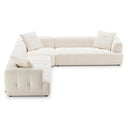 Kendall 120-inch L-shaped modular corner sectional sofa in textured ivory white boucle fabric, featuring low-profile grid-tufted seats, vertical channel stitching, and three matching throw pillows against a white background.