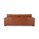 The rear view of the Kennon leather sofa, showing the vertical stitched panels on its back and its solid, grounded silhouette.