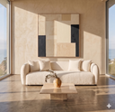 Lina 84 Ivory Boucle Sofa in a modern, sunlit living room with a travertine stone coffee table, abstract wall art, and scenic coastal ocean views through large windows.