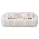 Front view of the Mazi 84-inch curved white French bouclé sofa featuring plush vertical channel tufting, rounded arms, a low-profile base, and four matching square throw pillows, isolated on a white background.
