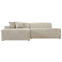 Melina 102-inch cream corduroy left-facing sectional sofa featuring ribbed textured upholstery, a low-profile silhouette, and two matching accent pillows on a clean white background.