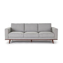 A front view of a gray upholstered Olwyn Sofa with a full wood base and wide track arms, presented against a white background.