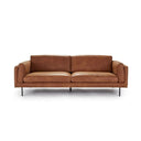 A brown, upholstered Rehan Sofa with a minimalist design, featuring a sleek backrest and seat with metallic accents.