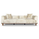 A modern low-profile Rosa 103 cream velvet sofa with plush velvet upholstery, a natural wood base frame, tapered wooden legs, and matching throw pillows, set against a solid white background.