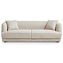 Modern cream luxury fabric sofa with curved armrests, two matching throw pillows, and low wooden feet isolated on a white background.