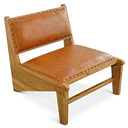 A low-profile, armless accent chair with warm tan leather upholstery on the seat and reclined backrest. The leather cushions are detailed with decorative nailhead trim along their edges, set in a solid light-toned natural wood frame with visible grain and a low, angled silhouette.