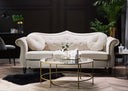 White sofa in a stylish living room with a gold coffee table and decorative plants.
