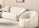 Modern living room with a white sofa and matching armchair, light-colored walls, and a decorative plant.